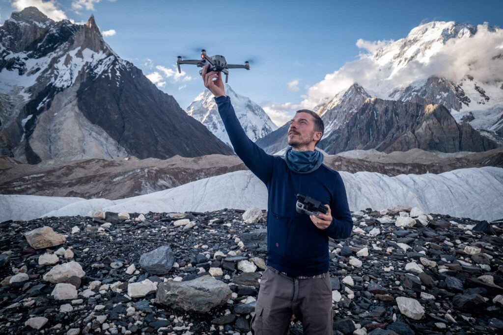Hiker flying a drone in the mountains