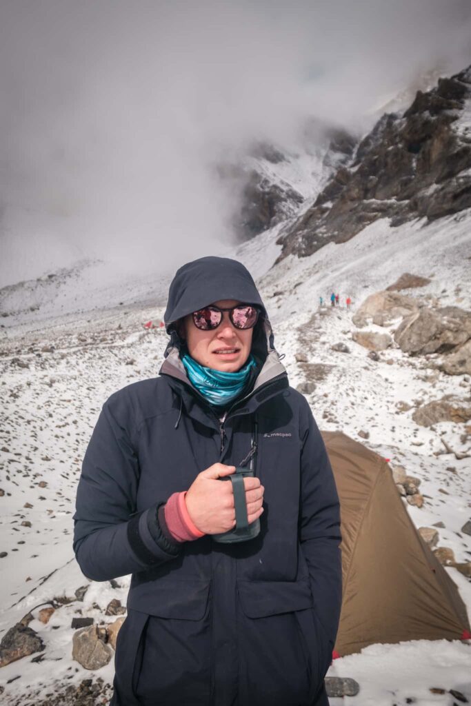 hiker in the snow with a coffee cup