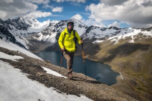 Man hiking in Bolivia with a camera on his shoulder strap