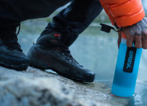 mountaineering boot on glacier with water filter