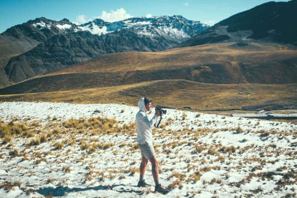 Man hiking with a large mirrorless camera