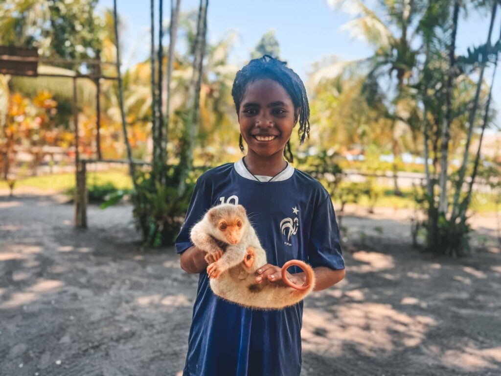 Lady holding a possum in PNG