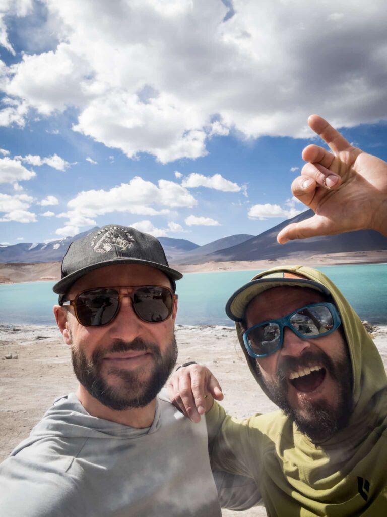 Excited hikers at a lake