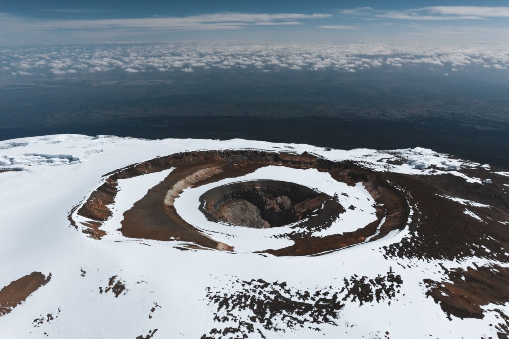 Aerial view of the snow-ringed Reusch Crater and ash pit on the summit of Mount Kilimanjaro, Tanzania